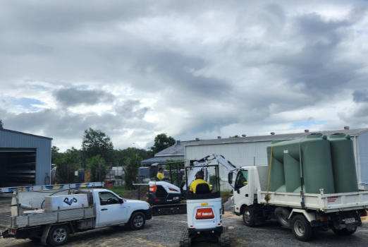 Excavators and ute in yard